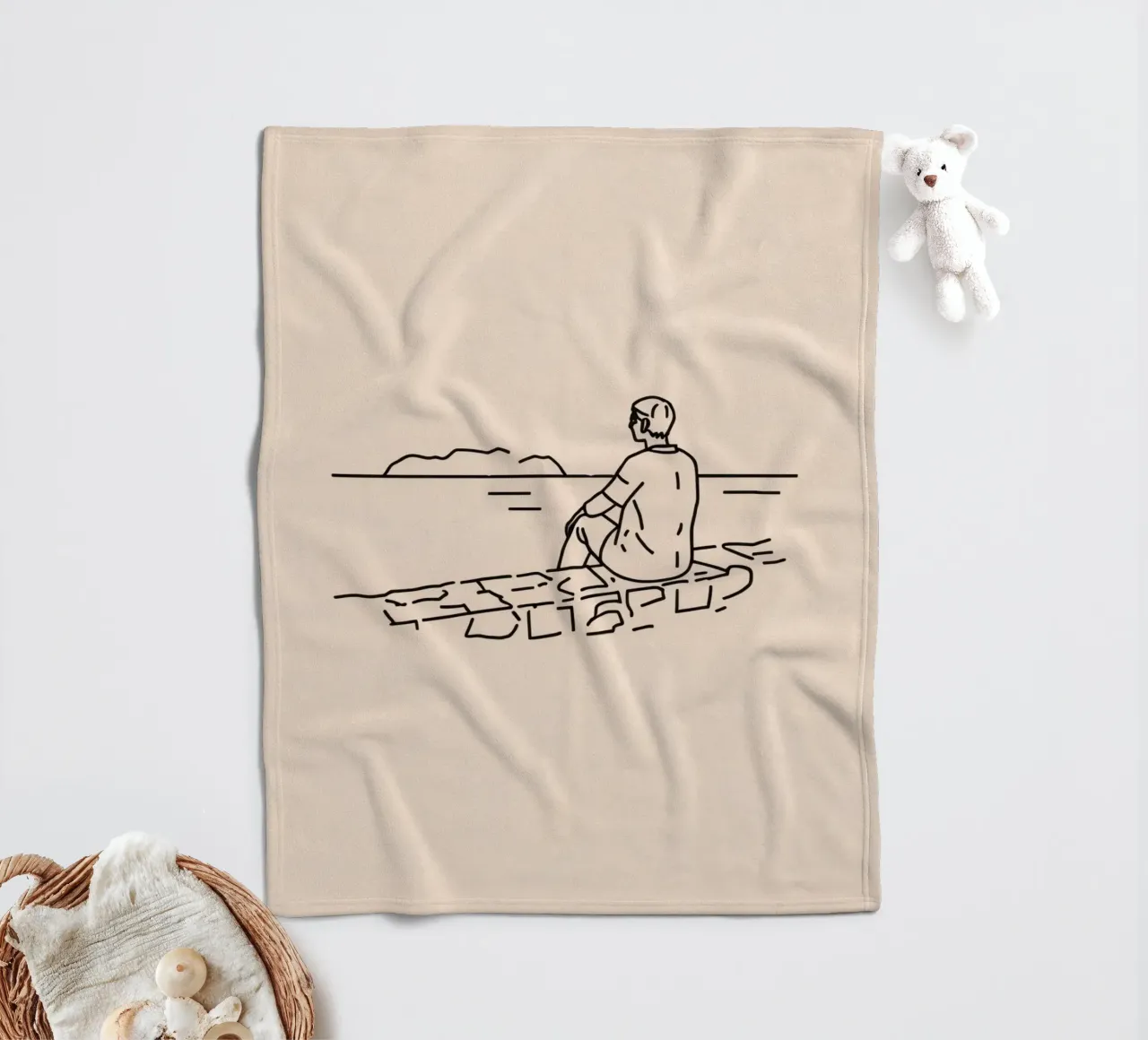 man reflects by the water while sitting on the shore fleece blanket by DesignDoodle