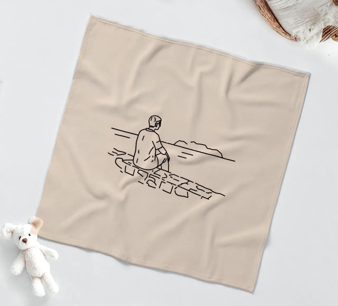 man reflects by the water while sitting on the shore fleece blanket by DesignDoodle