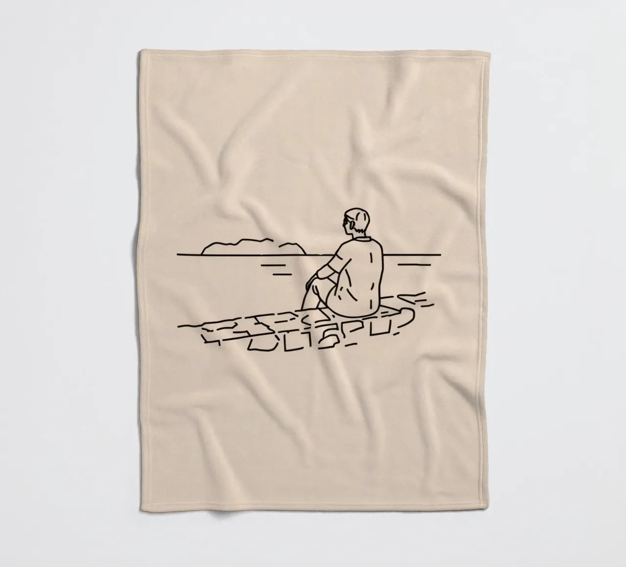 man reflects by the water while sitting on the shore fleece blanket by DesignDoodle