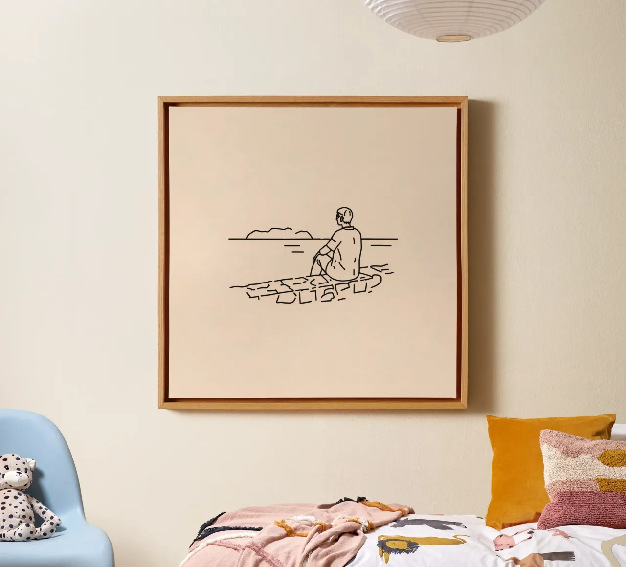 man reflects by the water while sitting on the shore canvas by DesignDoodle