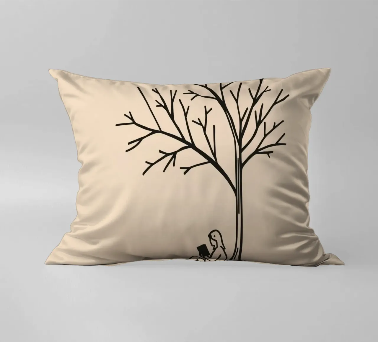 Persona che legge un libro sotto un albero spoglio in un pomeriggio caldo cuscino da DesignDoodle