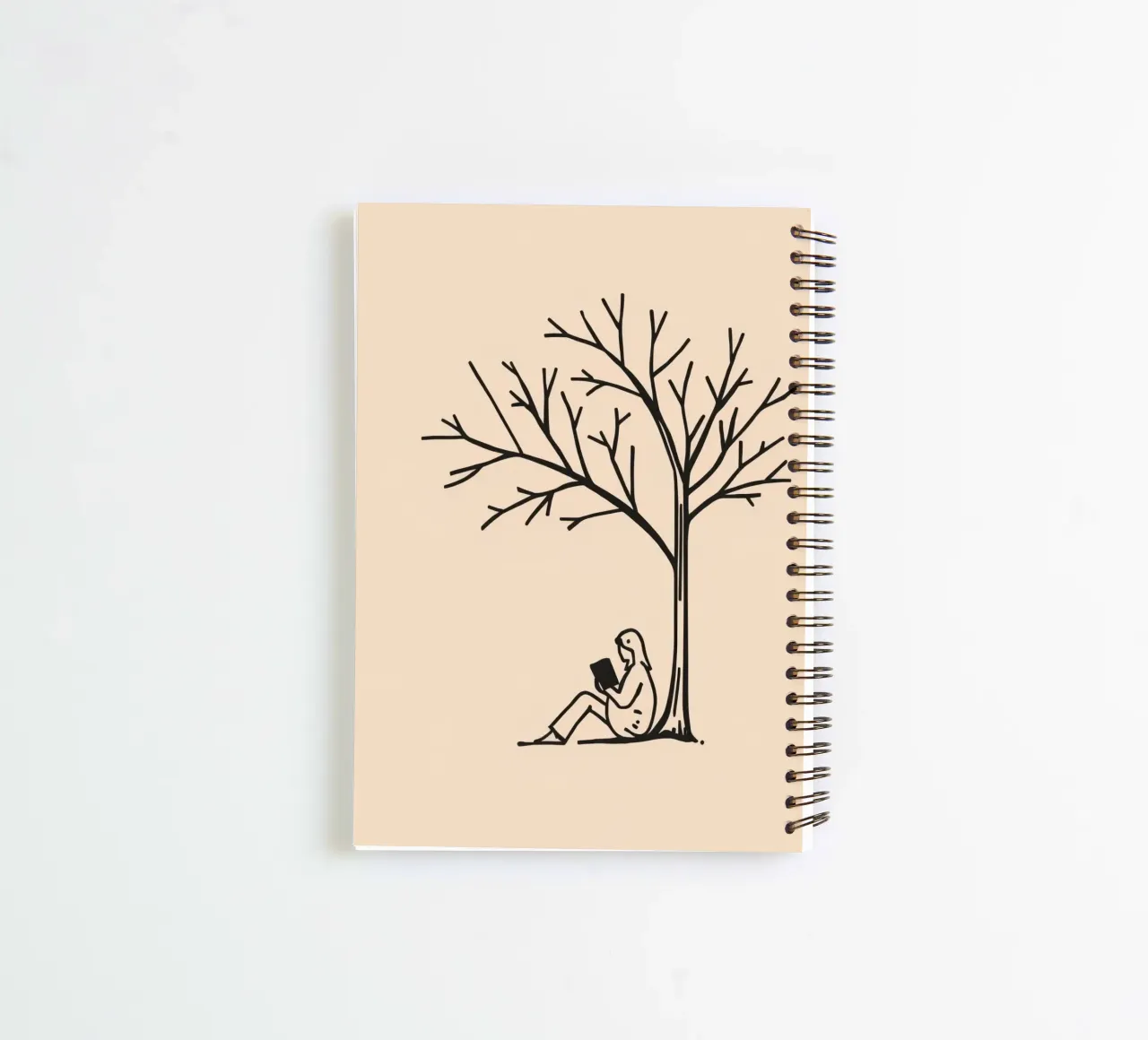 Person reading a book under a bare tree on a warm afternoon spiral notebook by DesignDoodle