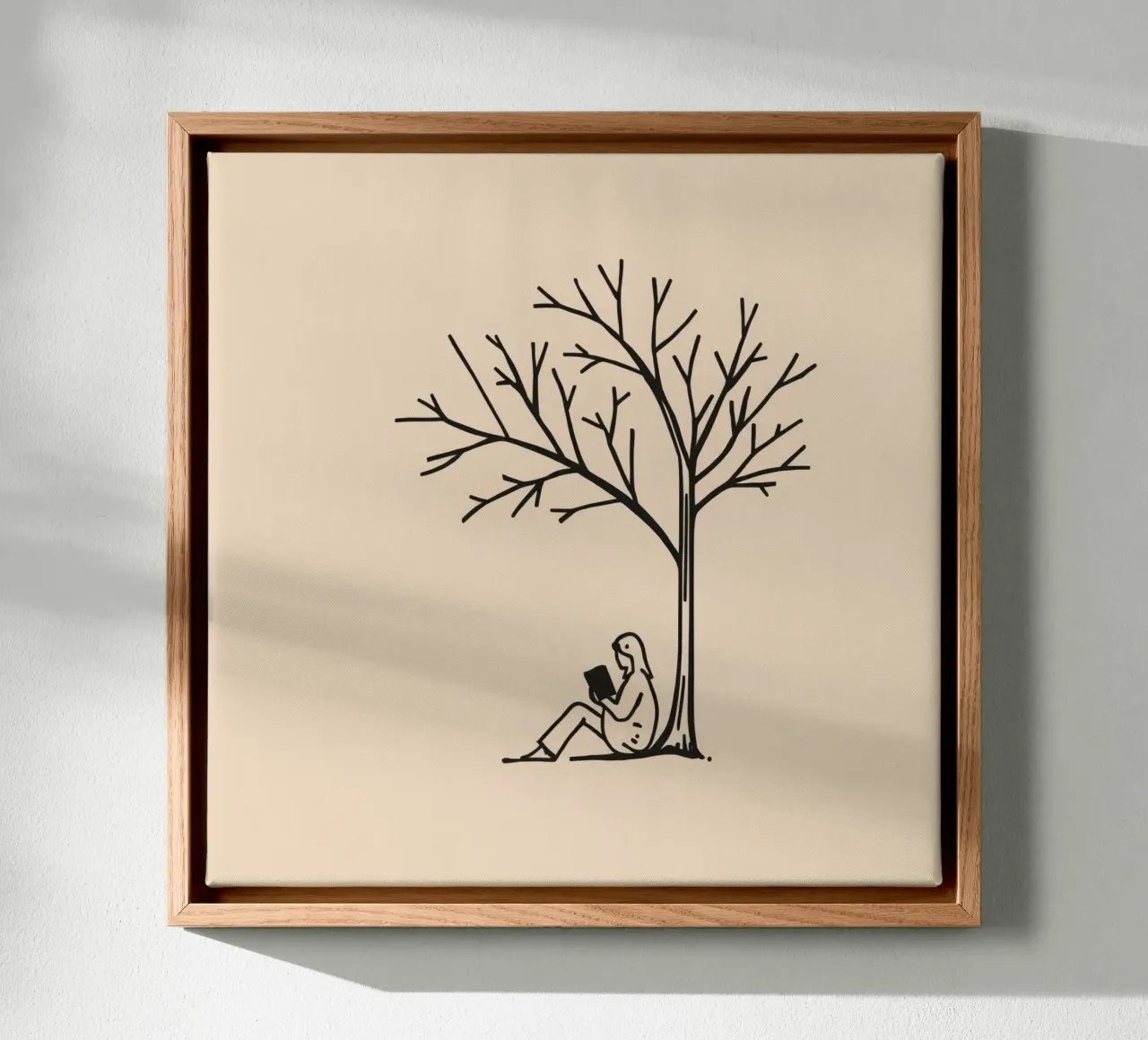 Person reading a book under a bare tree on a warm afternoon canvas by DesignDoodle