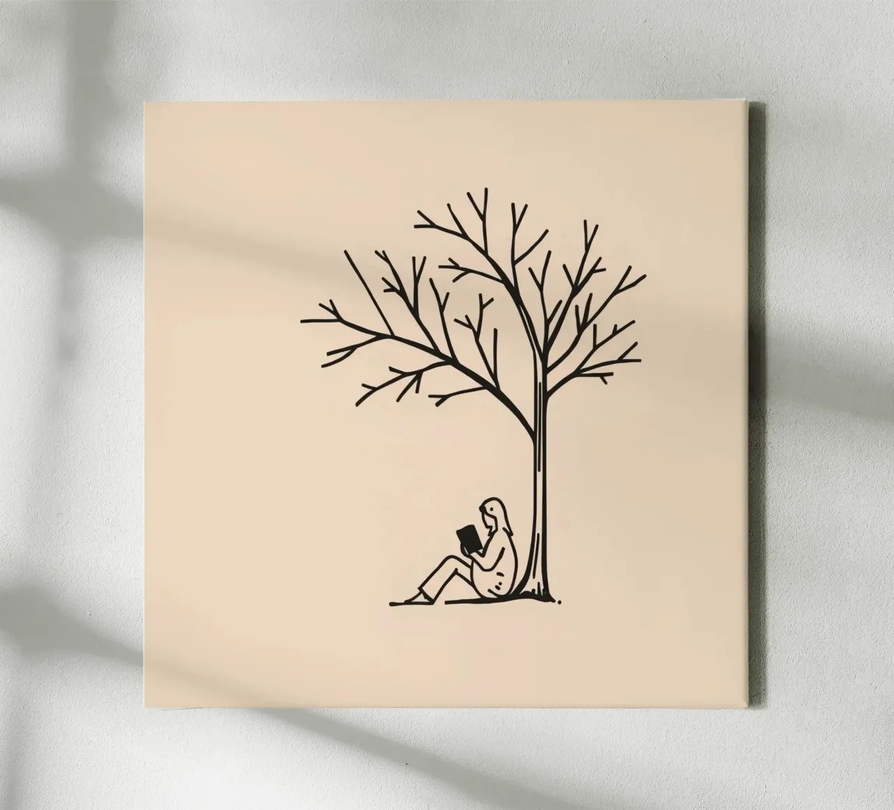 Person reading a book under a bare tree on a warm afternoon canvas by DesignDoodle