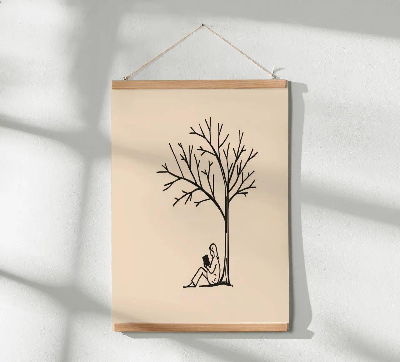 Person reading a book under a bare tree on a warm afternoon hahnemühle by DesignDoodle