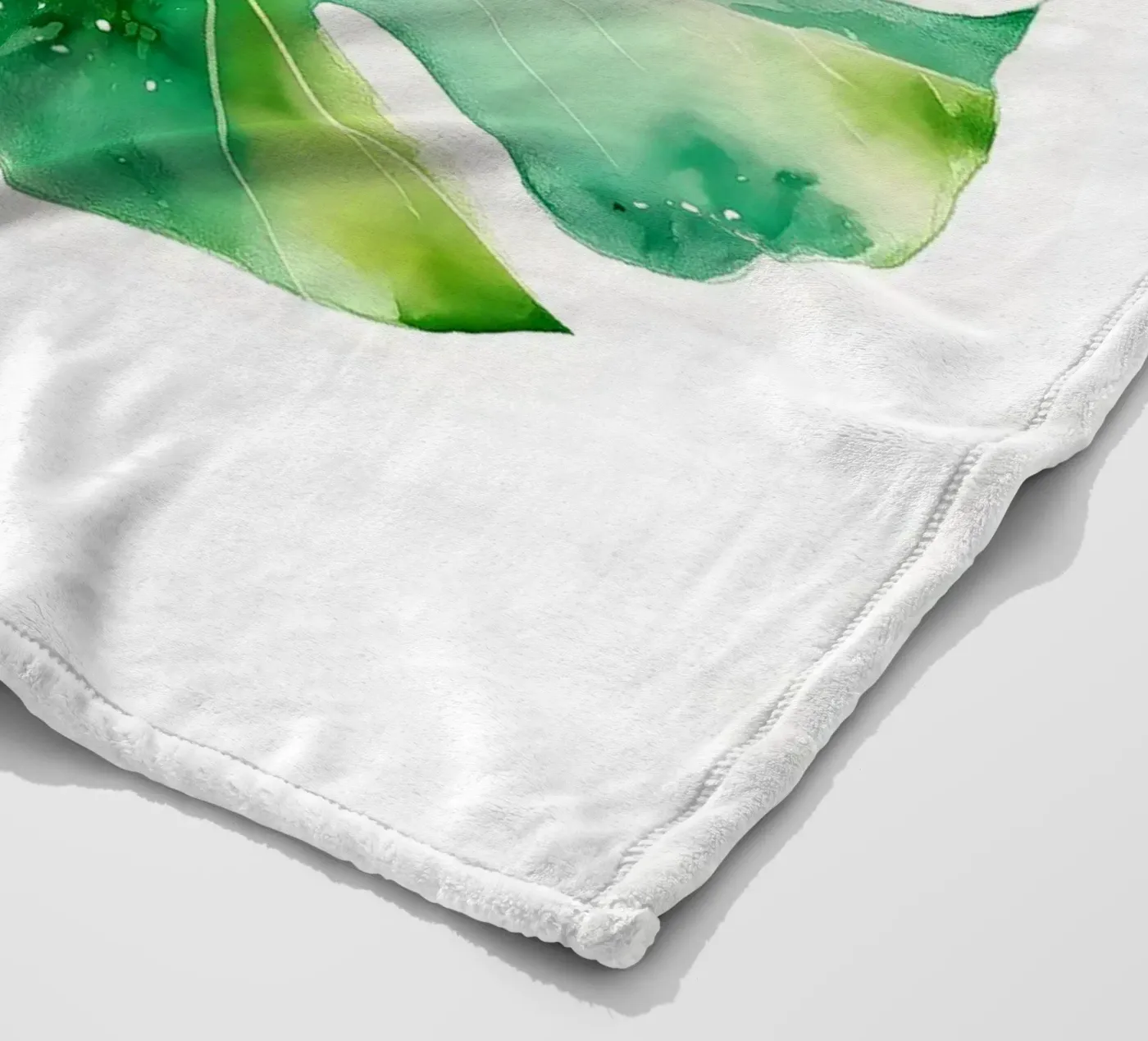 Monstera leaf fleece blanket by Studio Verde