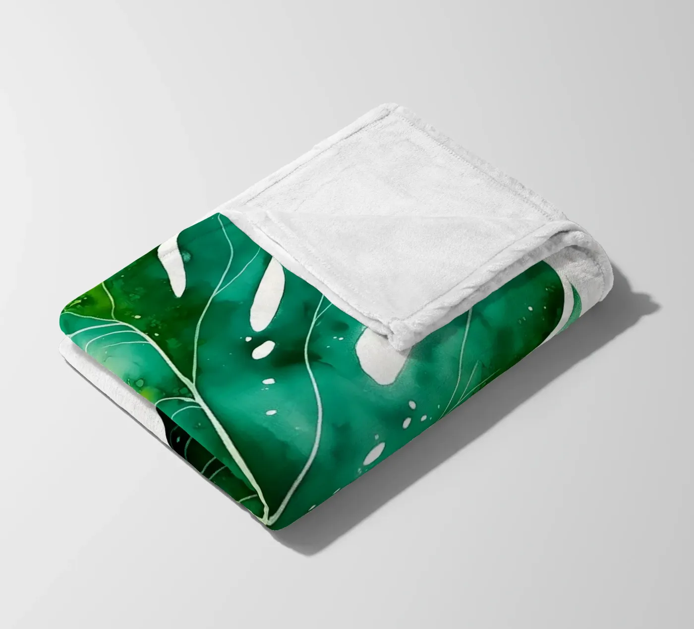 Monstera leaf fleece blanket by Studio Verde