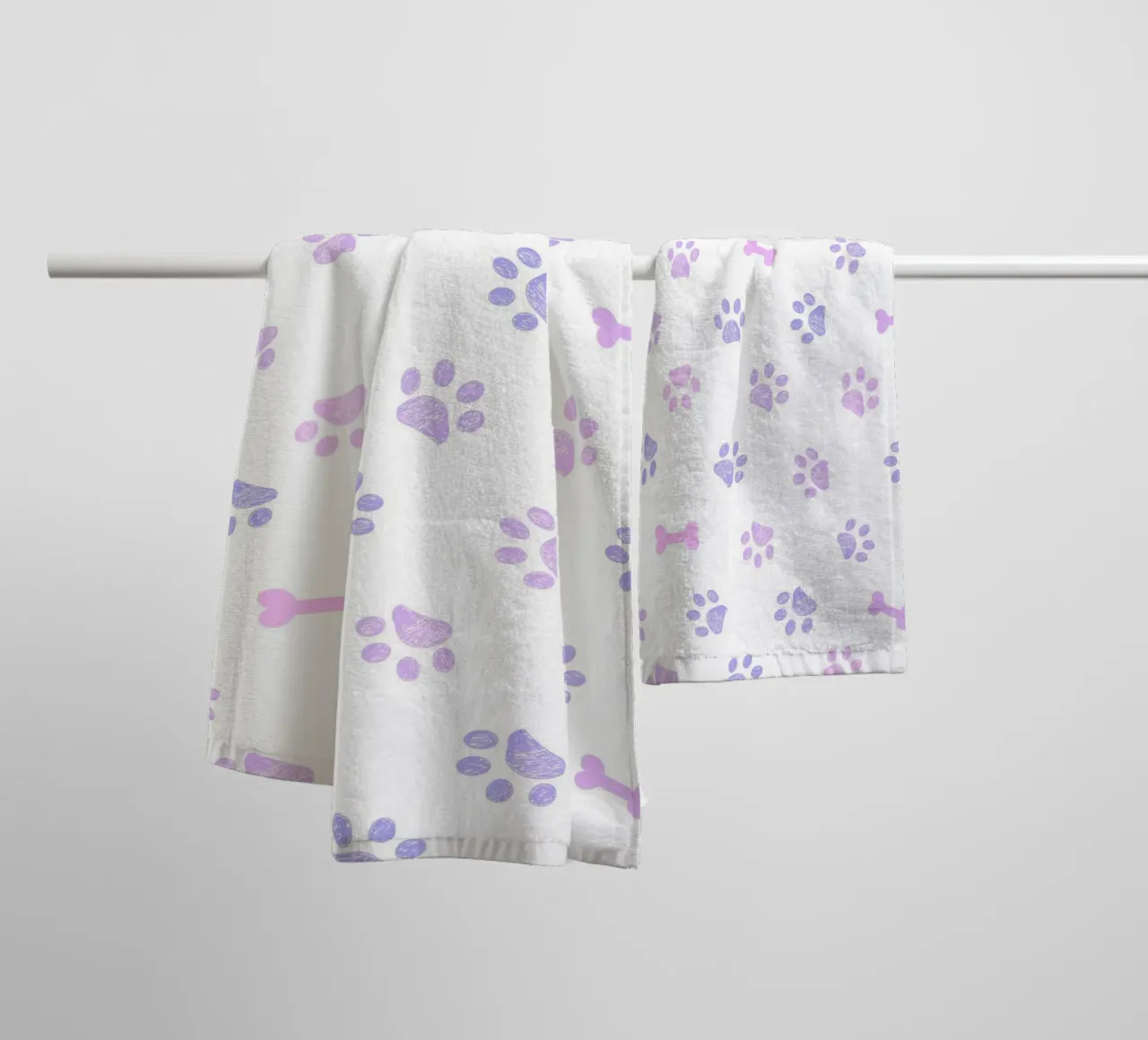 Lilac and pink colored doodles paw prints and bones towel by gulsengunel