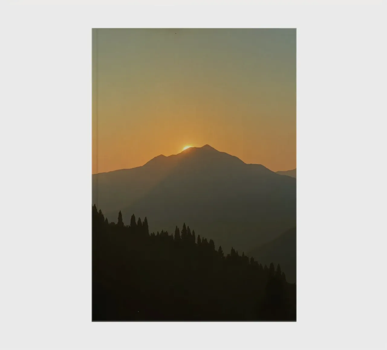 Zonsondergang werpt schaduwen over bergen en pijnbomen notitieboek van DesignDoodle