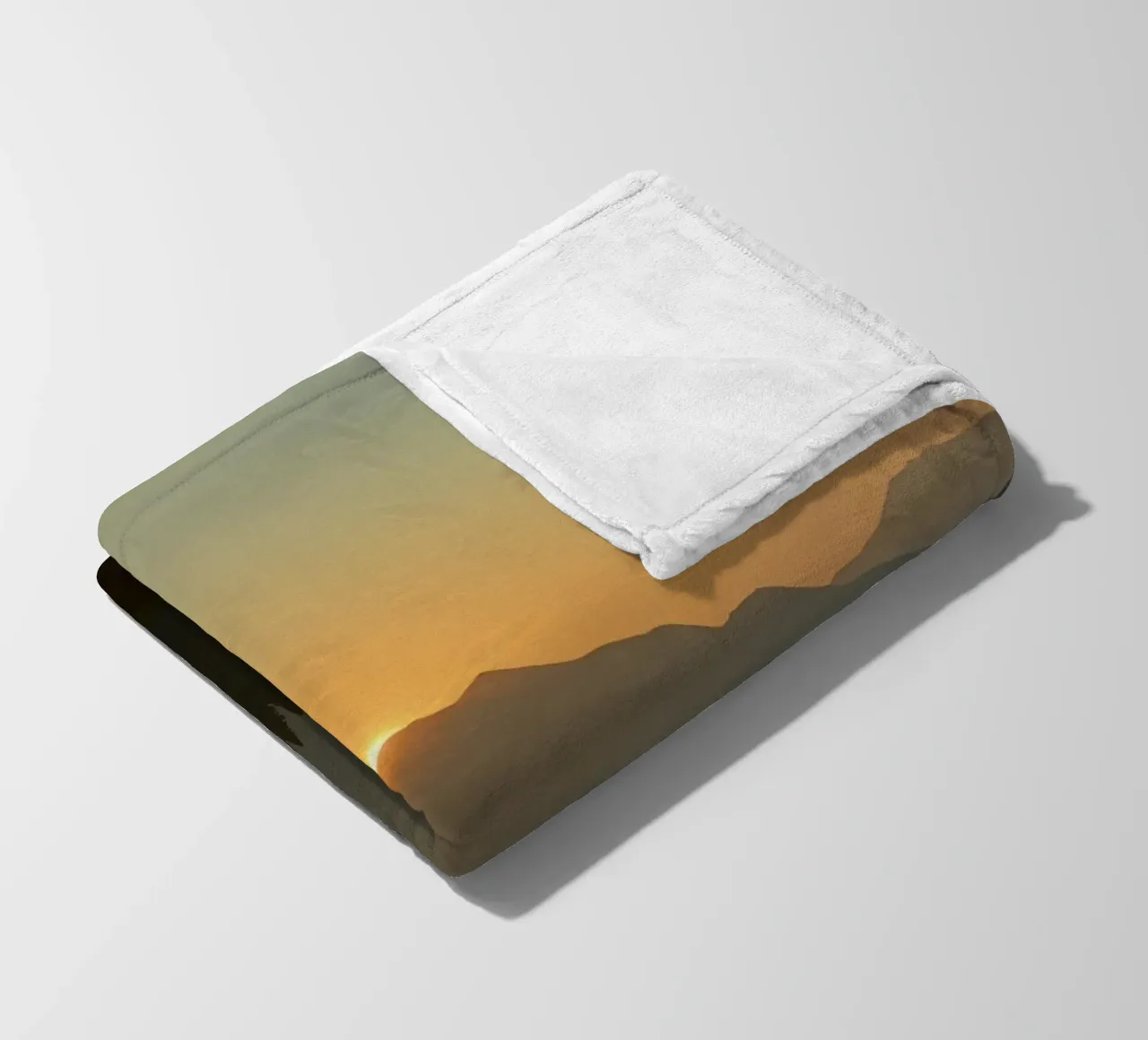 Sunset casting shadows over mountains and pine trees fleece blanket by DesignDoodle