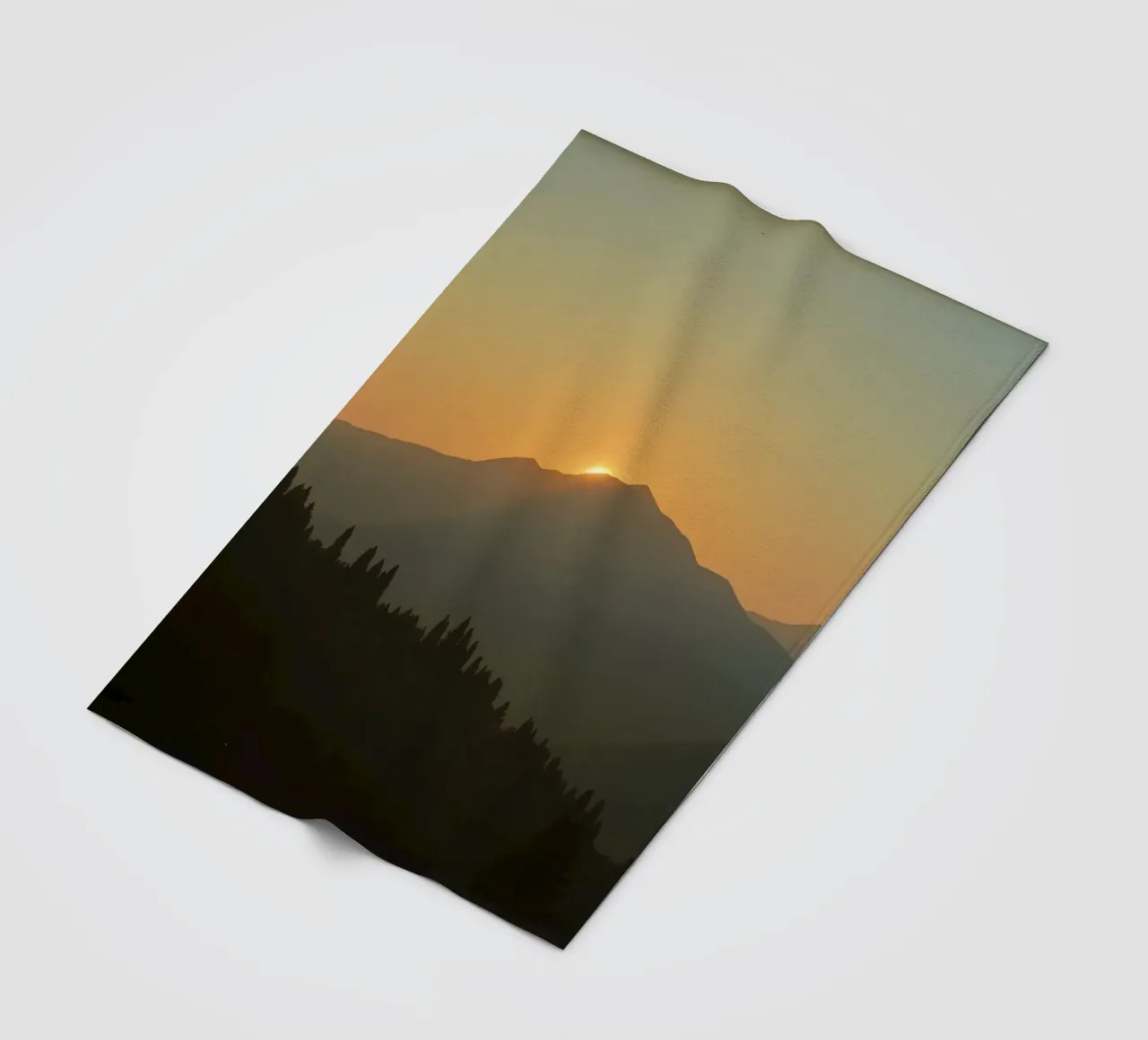 Sunset casting shadows over mountains and pine trees fleece blanket by DesignDoodle
