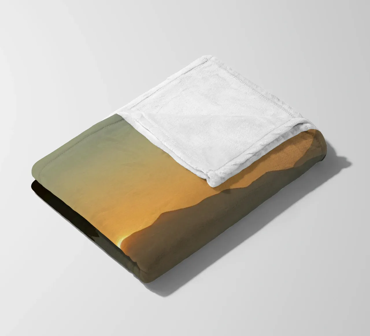 Sunset casting shadows over mountains and pine trees fleece blanket by DesignDoodle