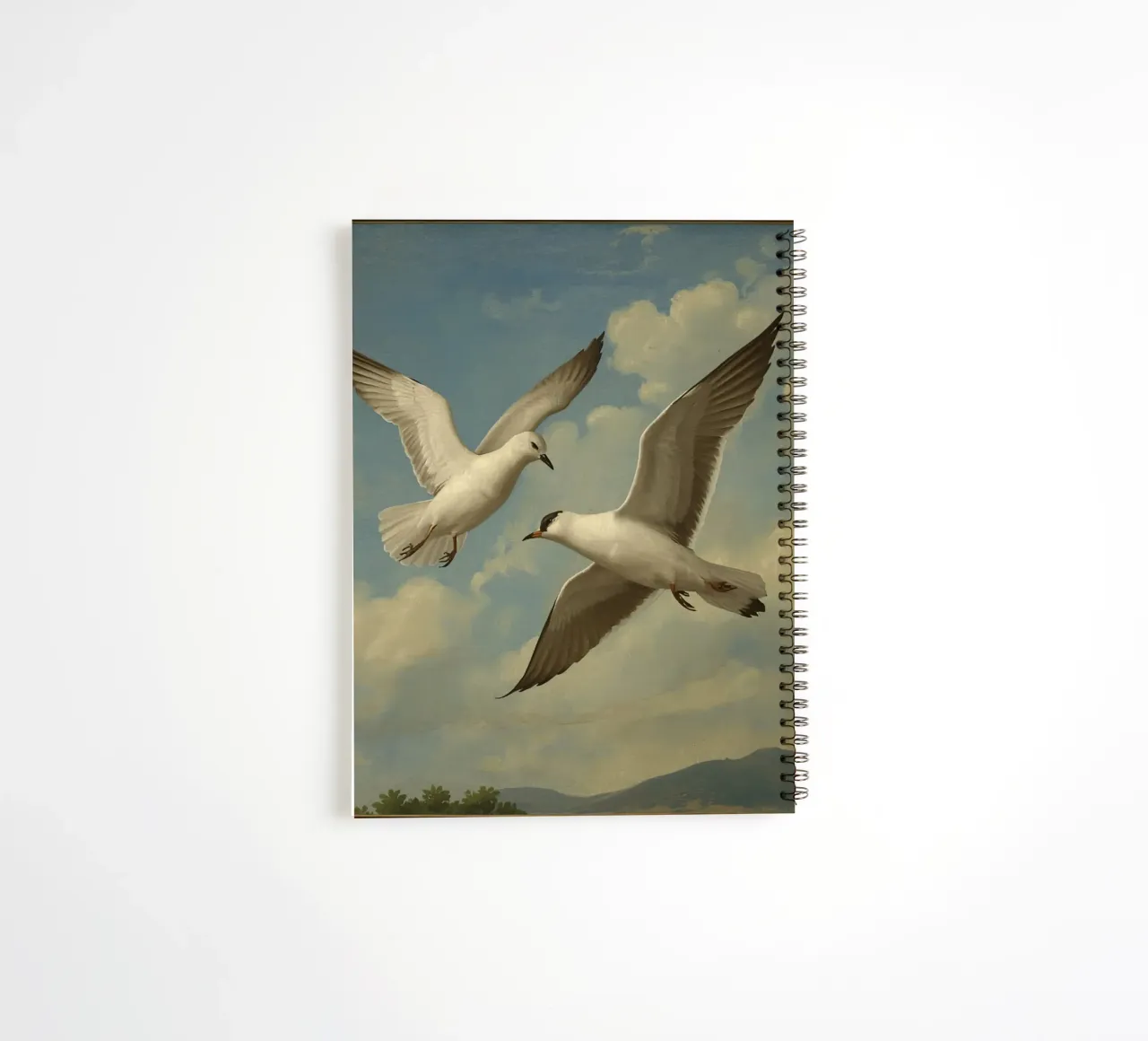 Two seagulls in mid-flight against a backdrop of clouds spiral notebook by DesignDoodle