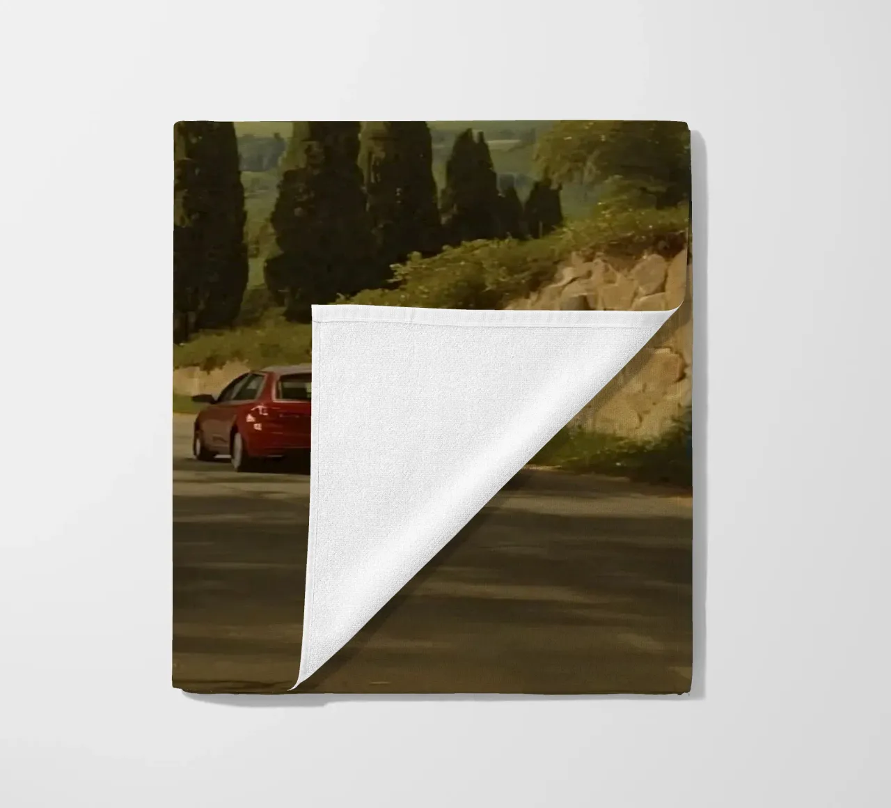 Superbe vue de la campagne avec une voiture roulant le long d'une route sinueuse. serviette de plage de DesignDoodle