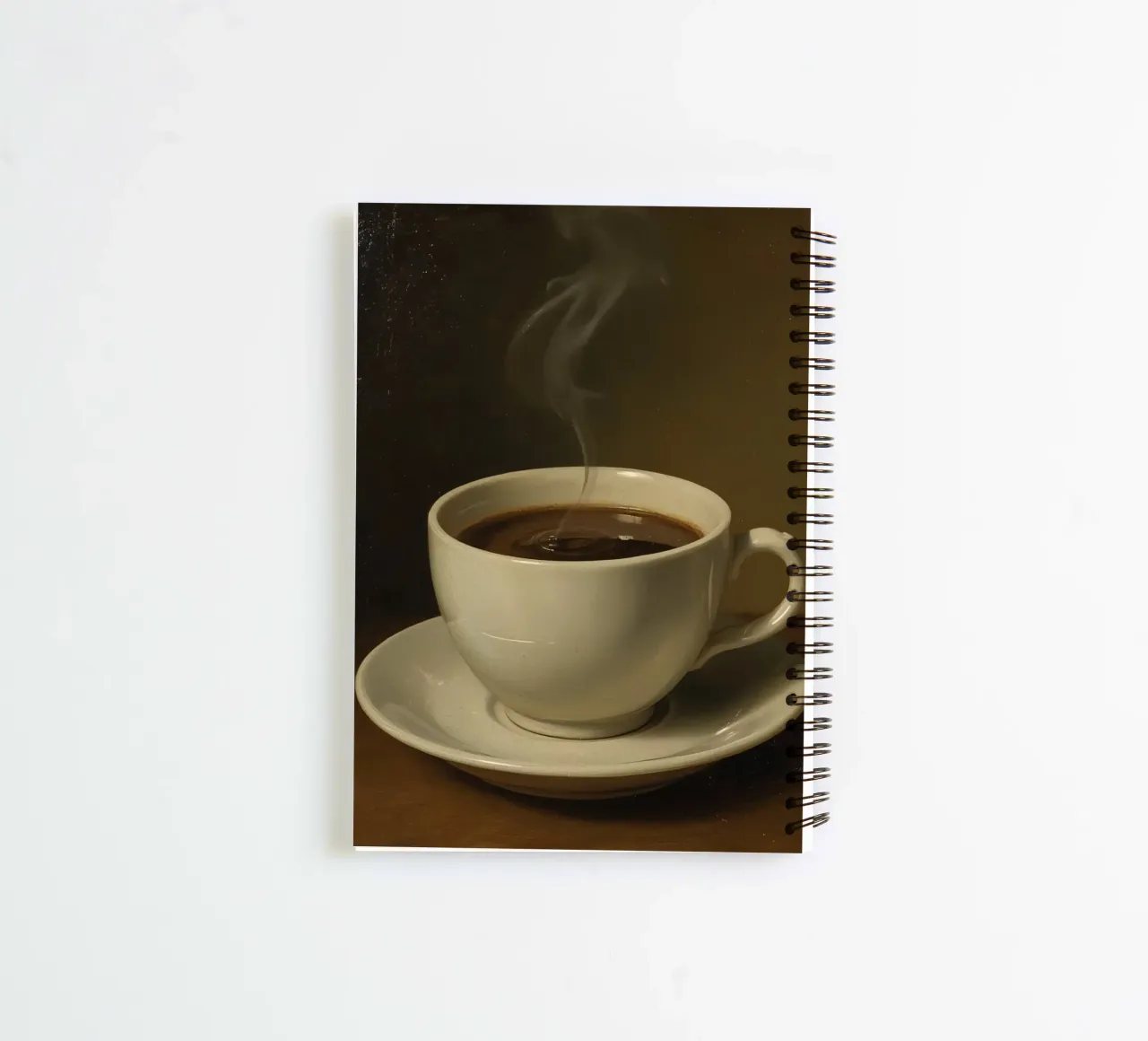 Coffee cup with steam resting on a saucer in a warm setting spiral notebook by DesignDoodle