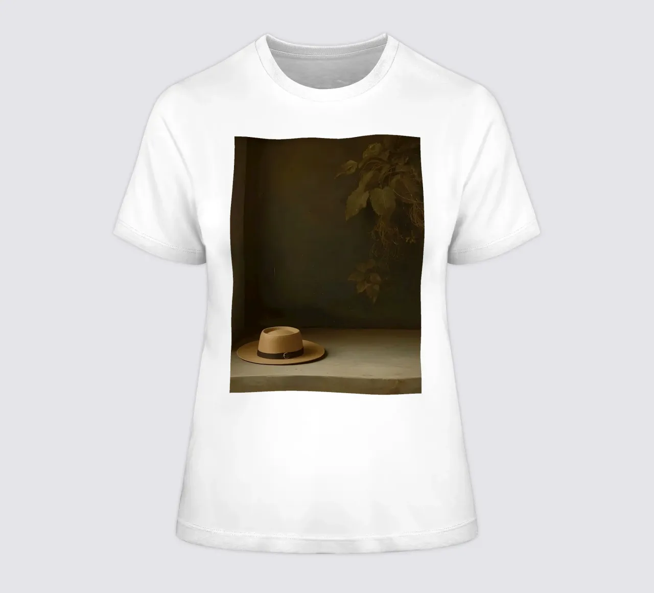 Hat resting on a surface with leaves in a muted setting women's fitted t-shirt by DesignDoodle