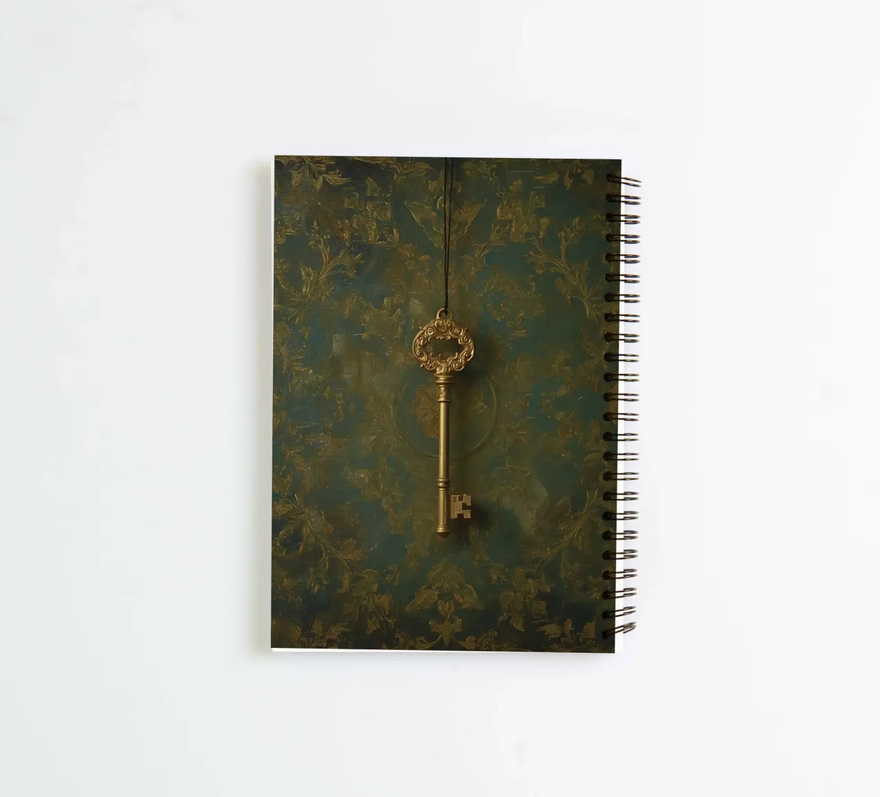 Key hanging against a textured background with intricate flo spiral notebook by DesignDoodle