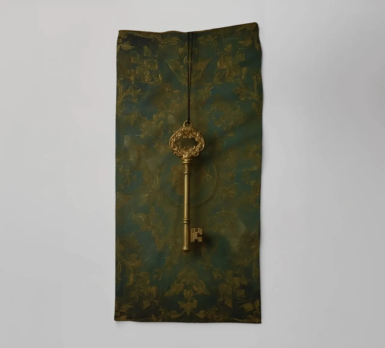 Key hanging against a textured background with intricate flo towel by DesignDoodle