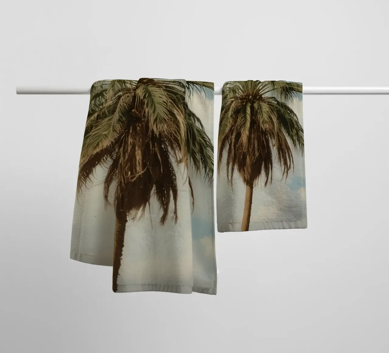 Palma alta con cielo blu e nuvole soffici in una luce calda. asciugamano da bagno da DesignDoodle