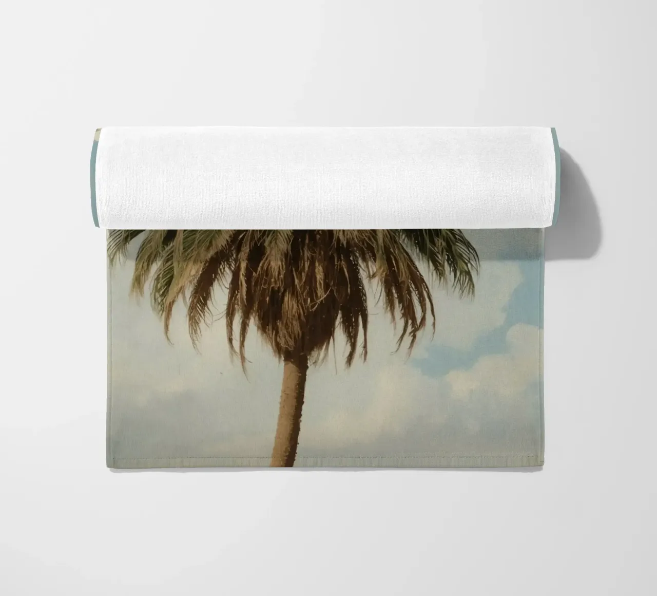 Palma alta con cielo blu e nuvole soffici in una luce calda. telo mare da DesignDoodle
