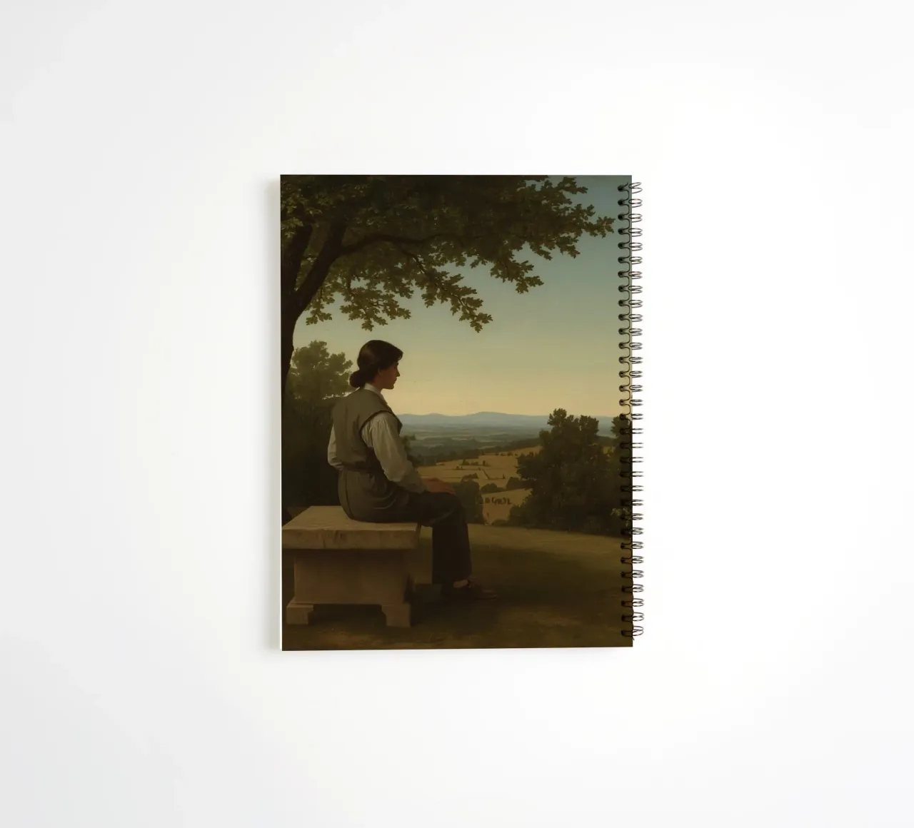 man seated on a stone bench reflecting on a landscape spiral notebook by DesignDoodle