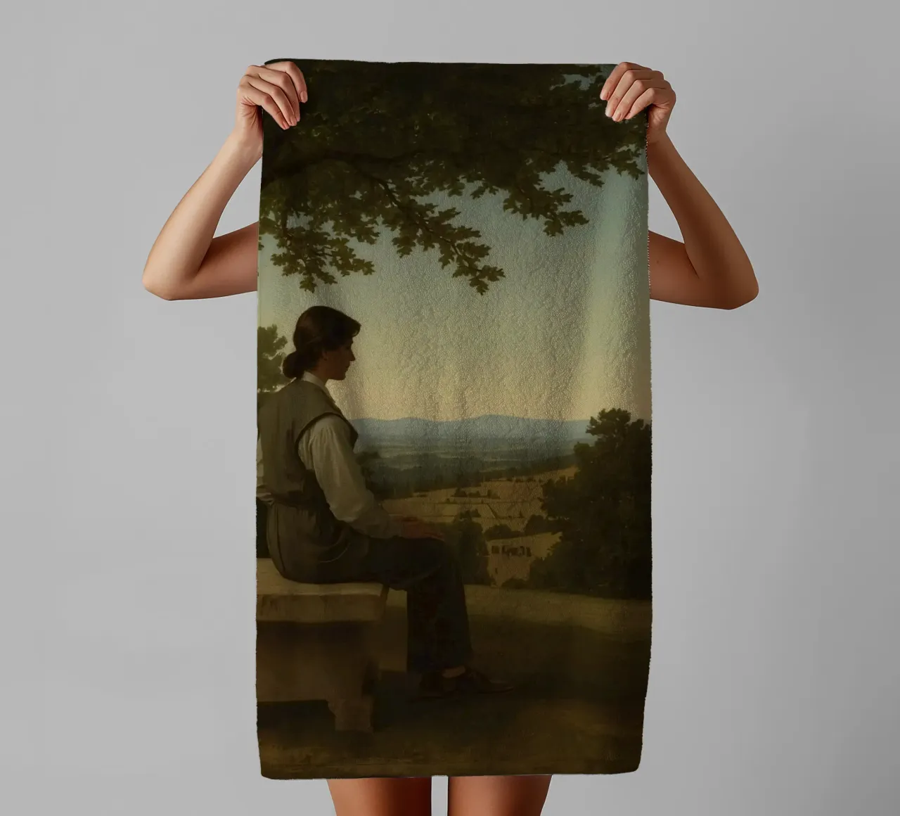 man seated on a stone bench reflecting on a landscape towel by DesignDoodle