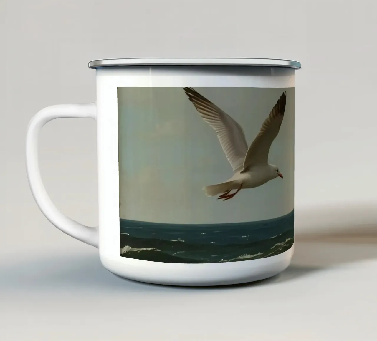 Seagull gliding over ocean waves under a partly cloudy sky enamel mug by DesignDoodle