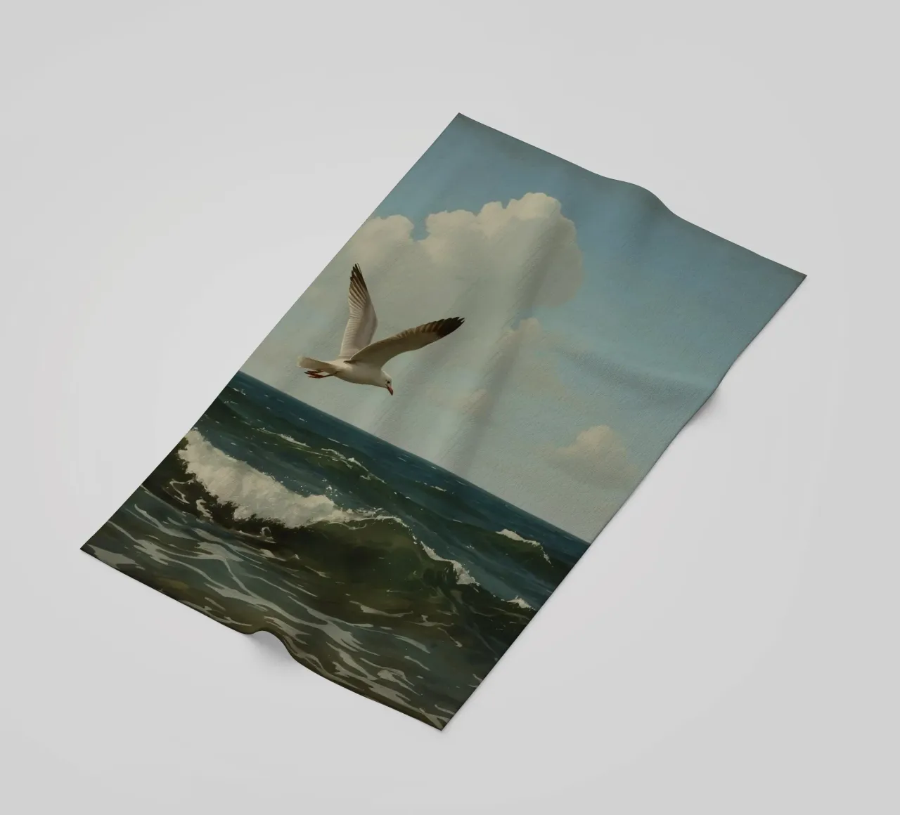 Seagull gliding over ocean waves under a partly cloudy sky beach towel by DesignDoodle