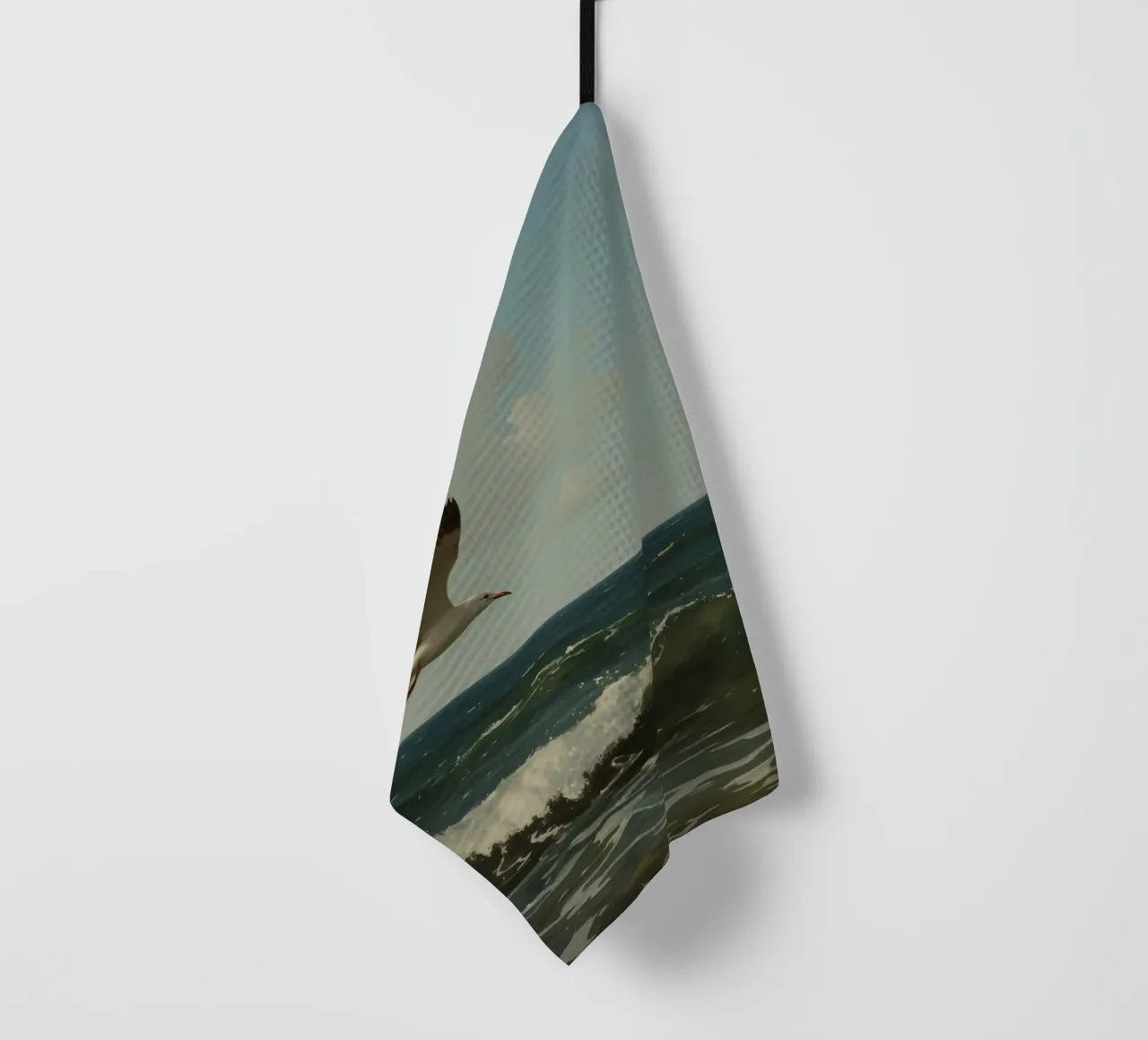Seagull gliding over ocean waves under a partly cloudy sky tea towel by DesignDoodle