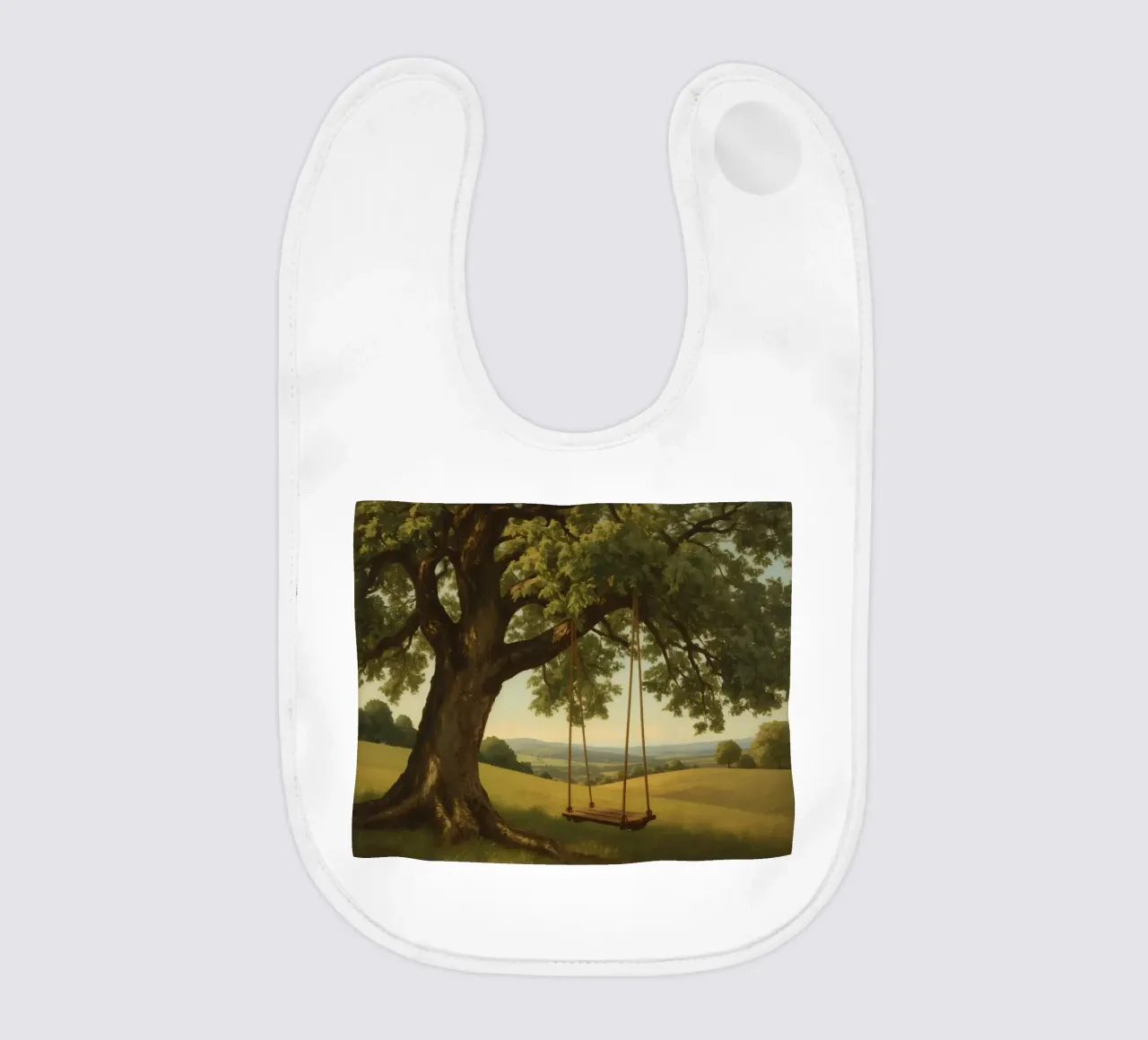 Swing hanging from a large tree overlooking rolling hills baby bib by DesignDoodle