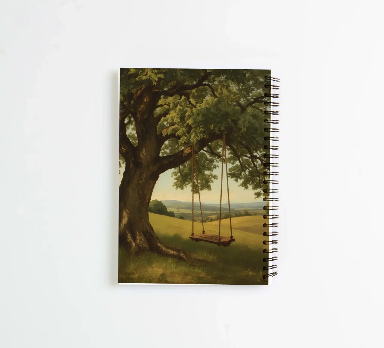Swing hanging from a large tree overlooking rolling hills spiral notebook by DesignDoodle