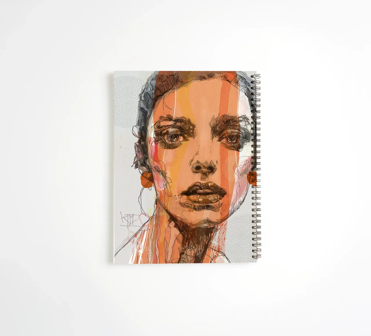 orange spiral notebook by Giulio Iurissevich