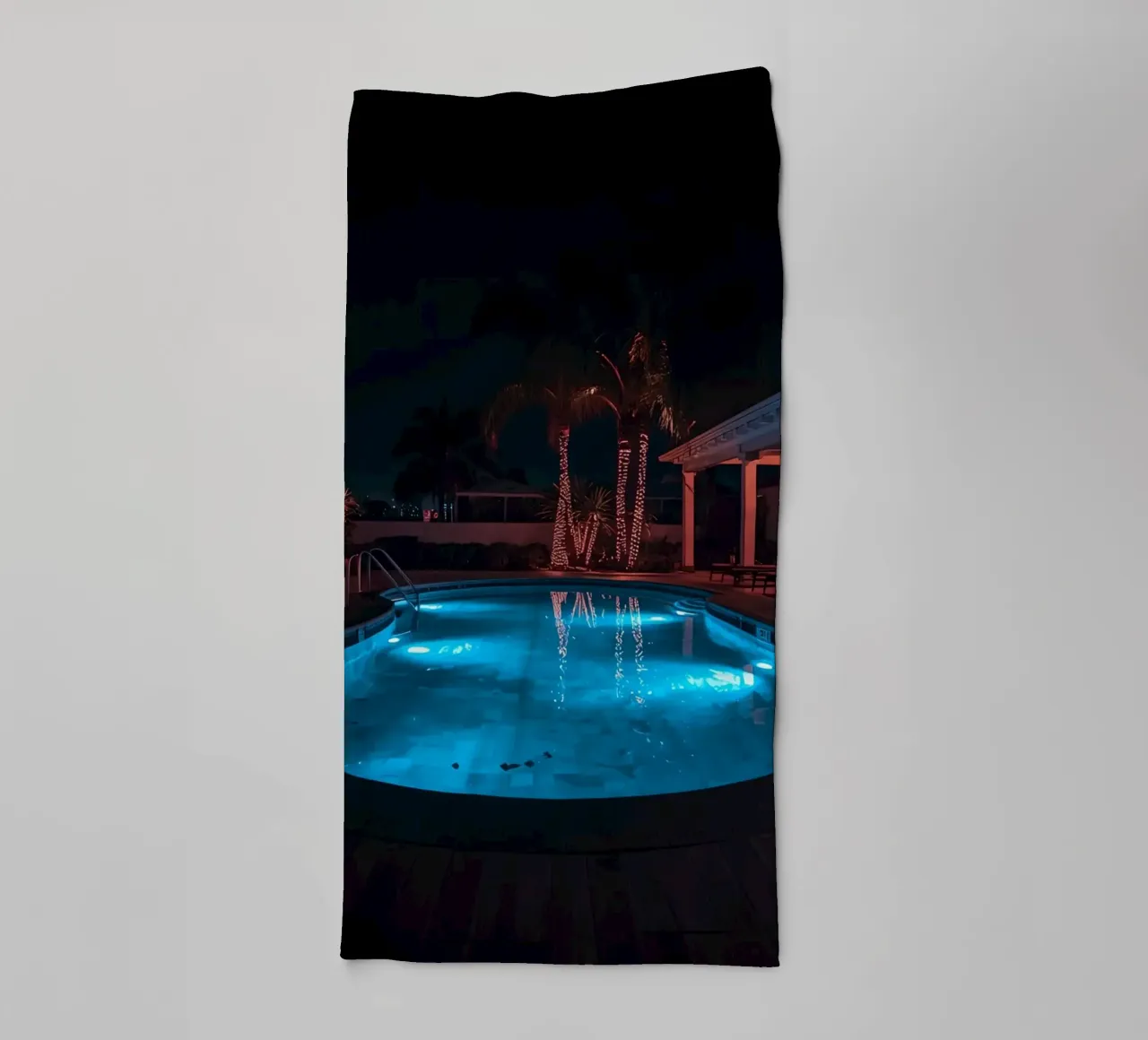 Illuminated Swimming Pool with Palm Trees towel by DesignDoodle