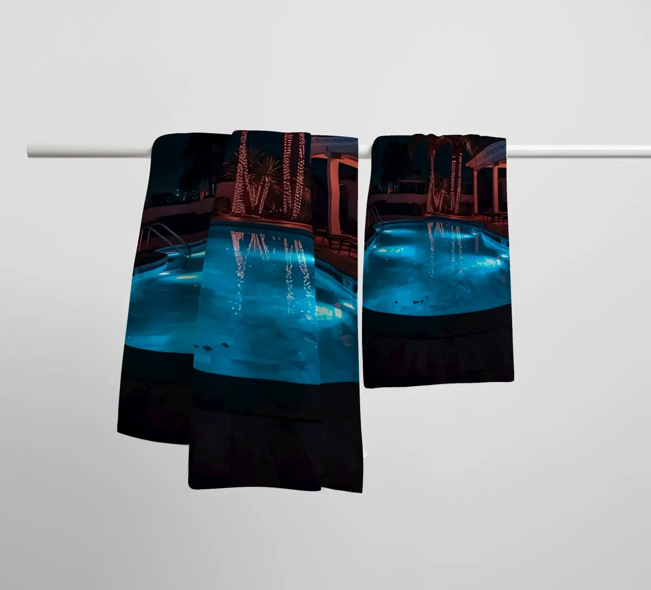 Illuminated Swimming Pool with Palm Trees towel by DesignDoodle