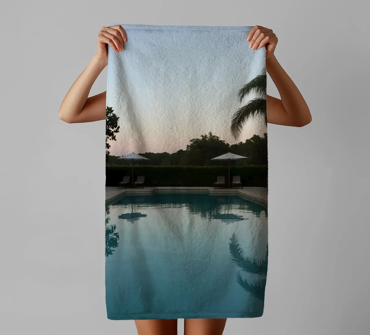 Swimming Pool Reflecting Palm Trees and Umbrellas at Dusk towel by DesignDoodle
