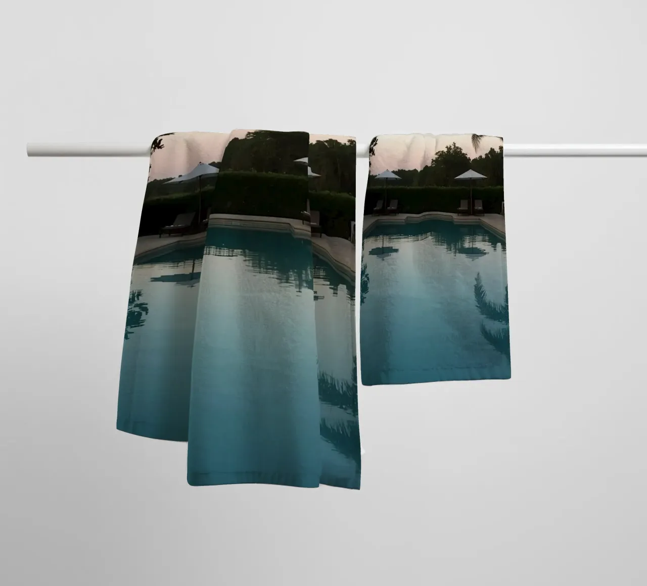 Swimming Pool Reflecting Palm Trees and Umbrellas at Dusk towel by DesignDoodle