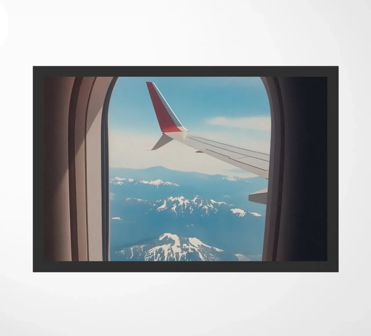 Vue d'un hublot d'avion sur une aile et des montagnes paillasson de DesignDoodle