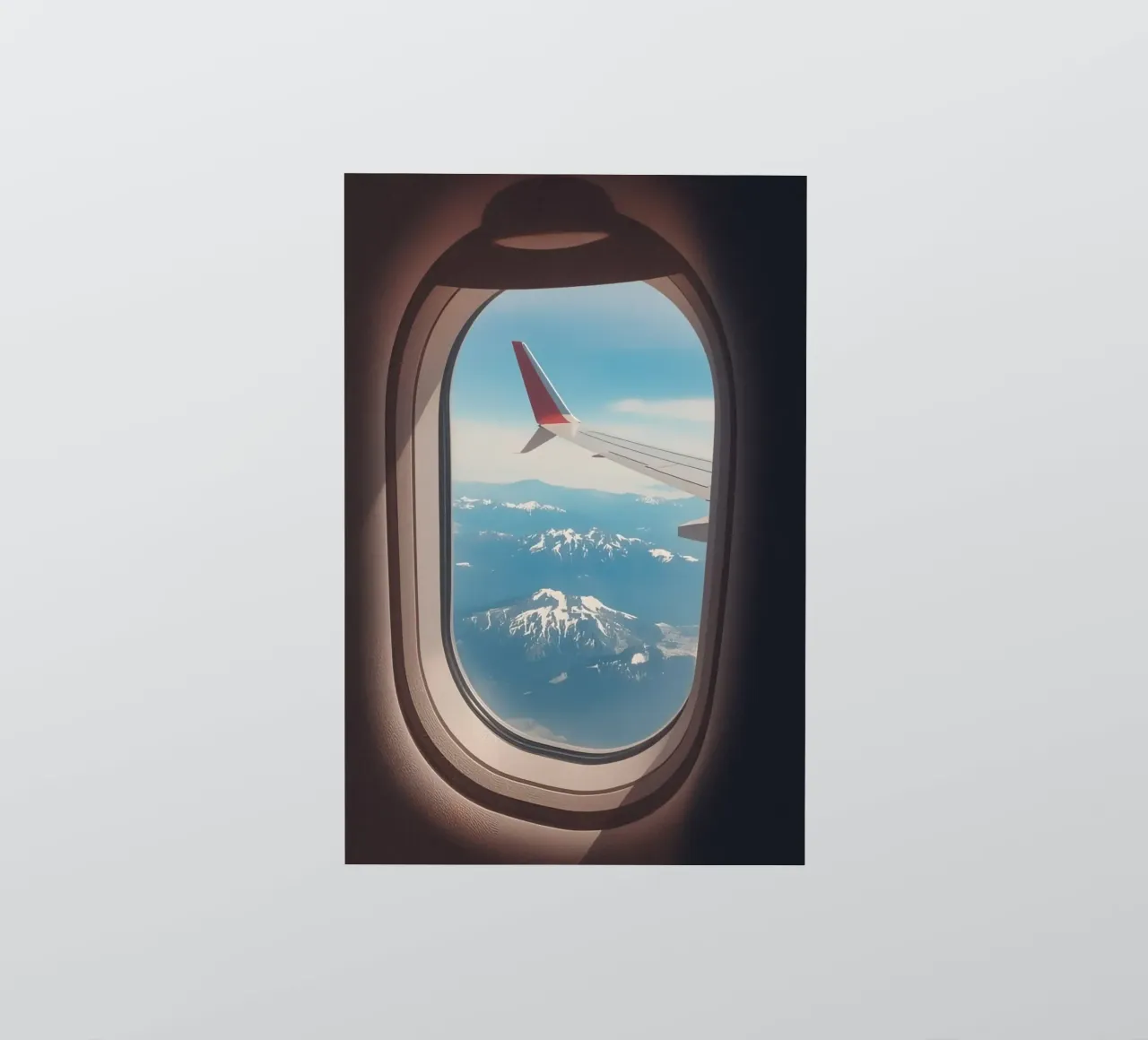 Vue d'un hublot d'avion sur une aile et des montagnes autocollant de DesignDoodle
