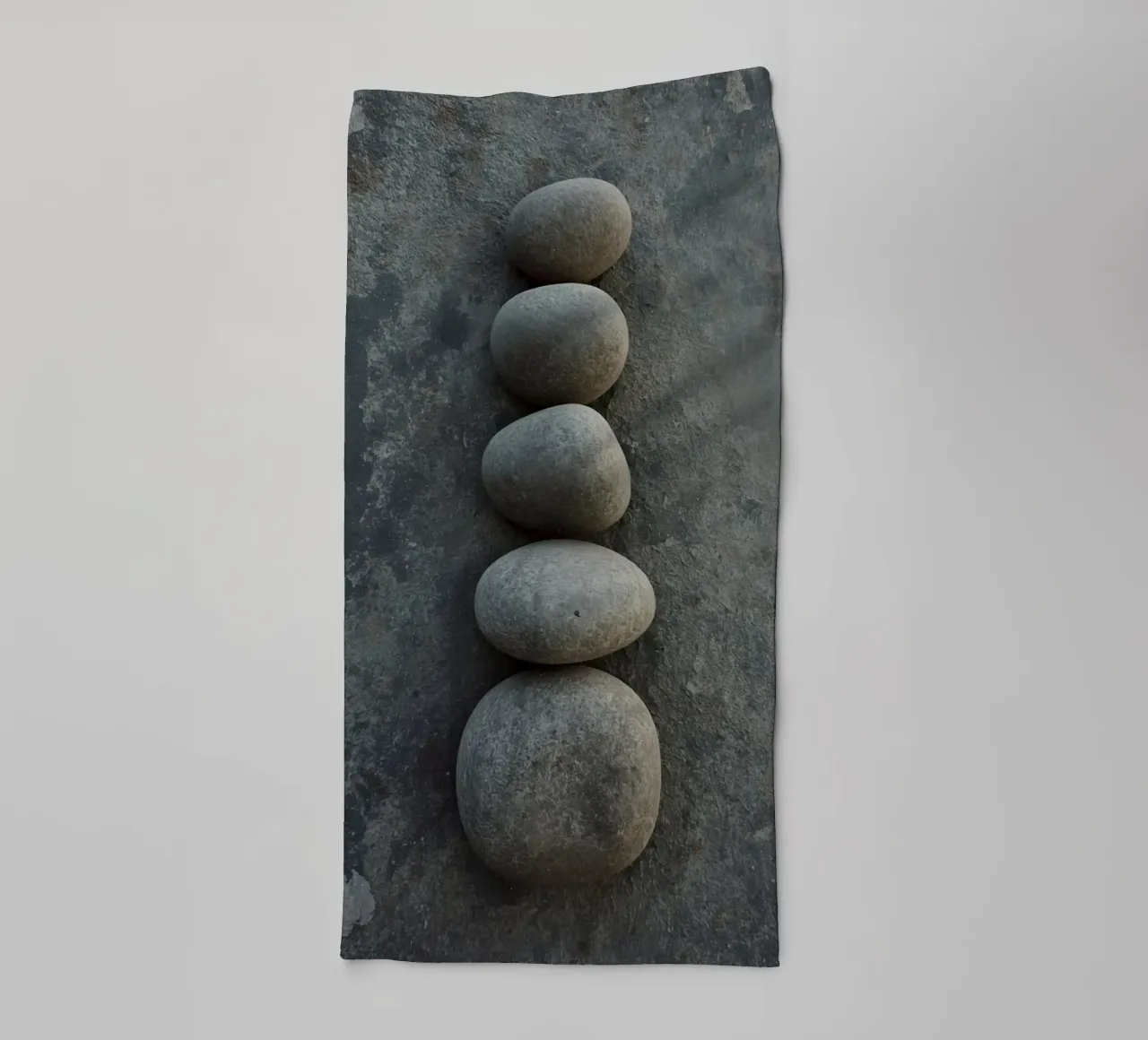 Five Gray Stones Stacked Vertically on Textured Surface towel by DesignDoodle