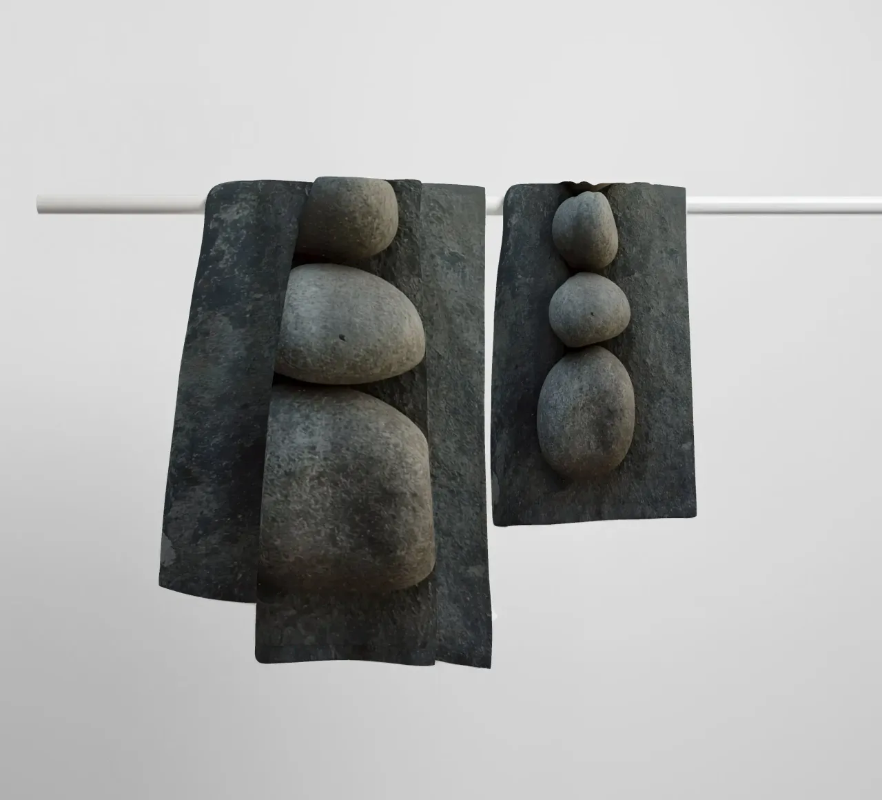 Five Gray Stones Stacked Vertically on Textured Surface towel by DesignDoodle