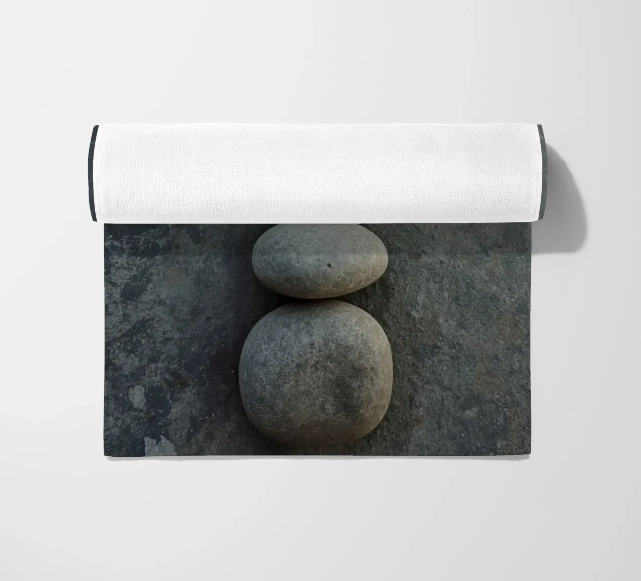 Cinque pietre grigie impilate verticalmente su una superficie strutturata telo mare da DesignDoodle