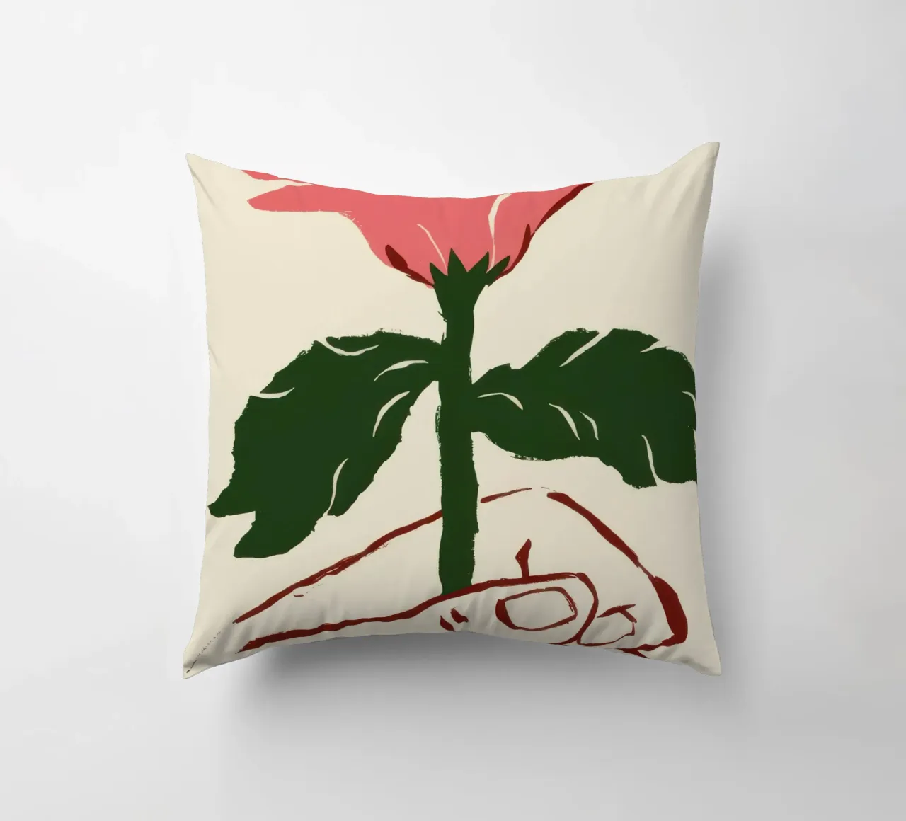 Mano che tiene un fiore rosa cuscino da Lyra Glaze