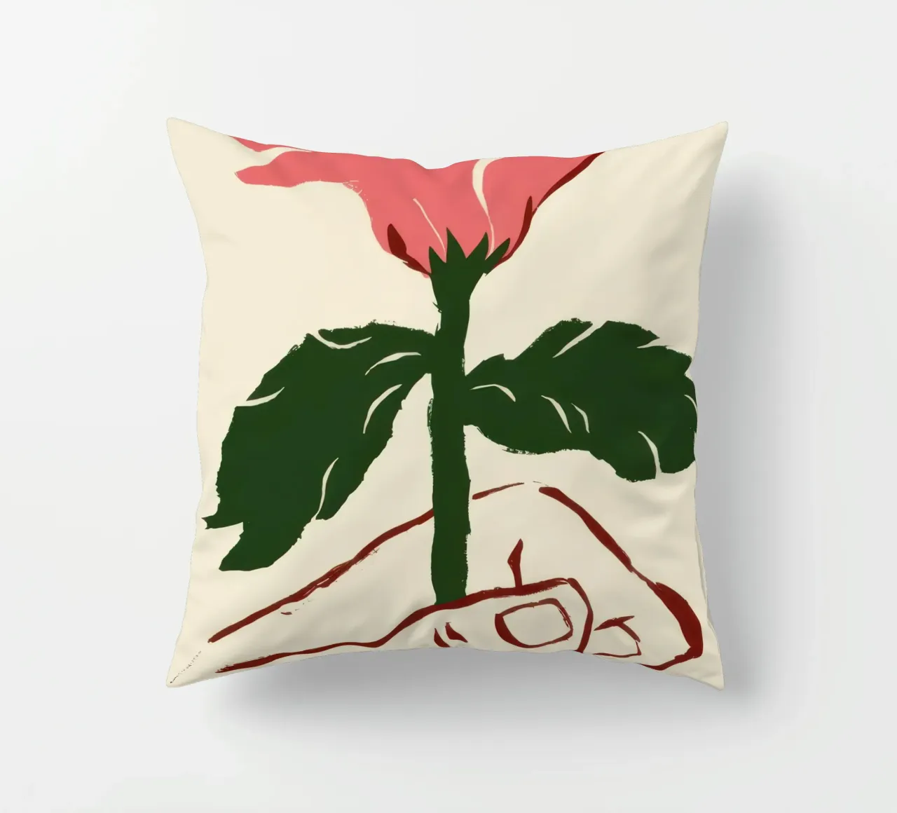 Mano che tiene un fiore rosa cuscino da Lyra Glaze
