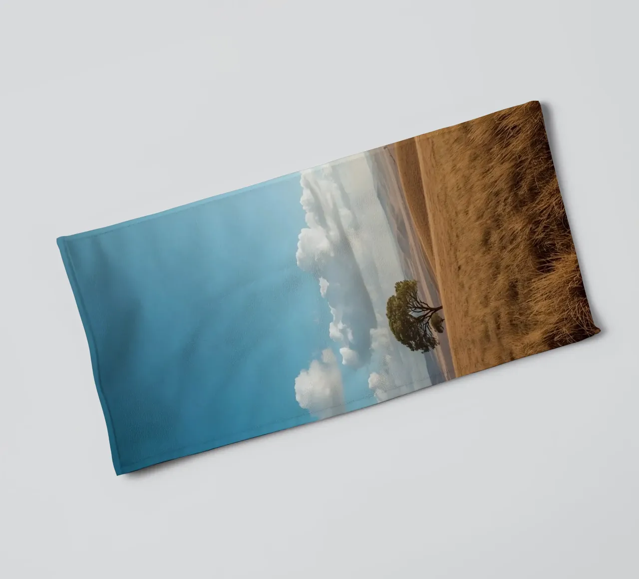Grass Field with Tree under Cloudy Blue Sky towel by DesignDoodle