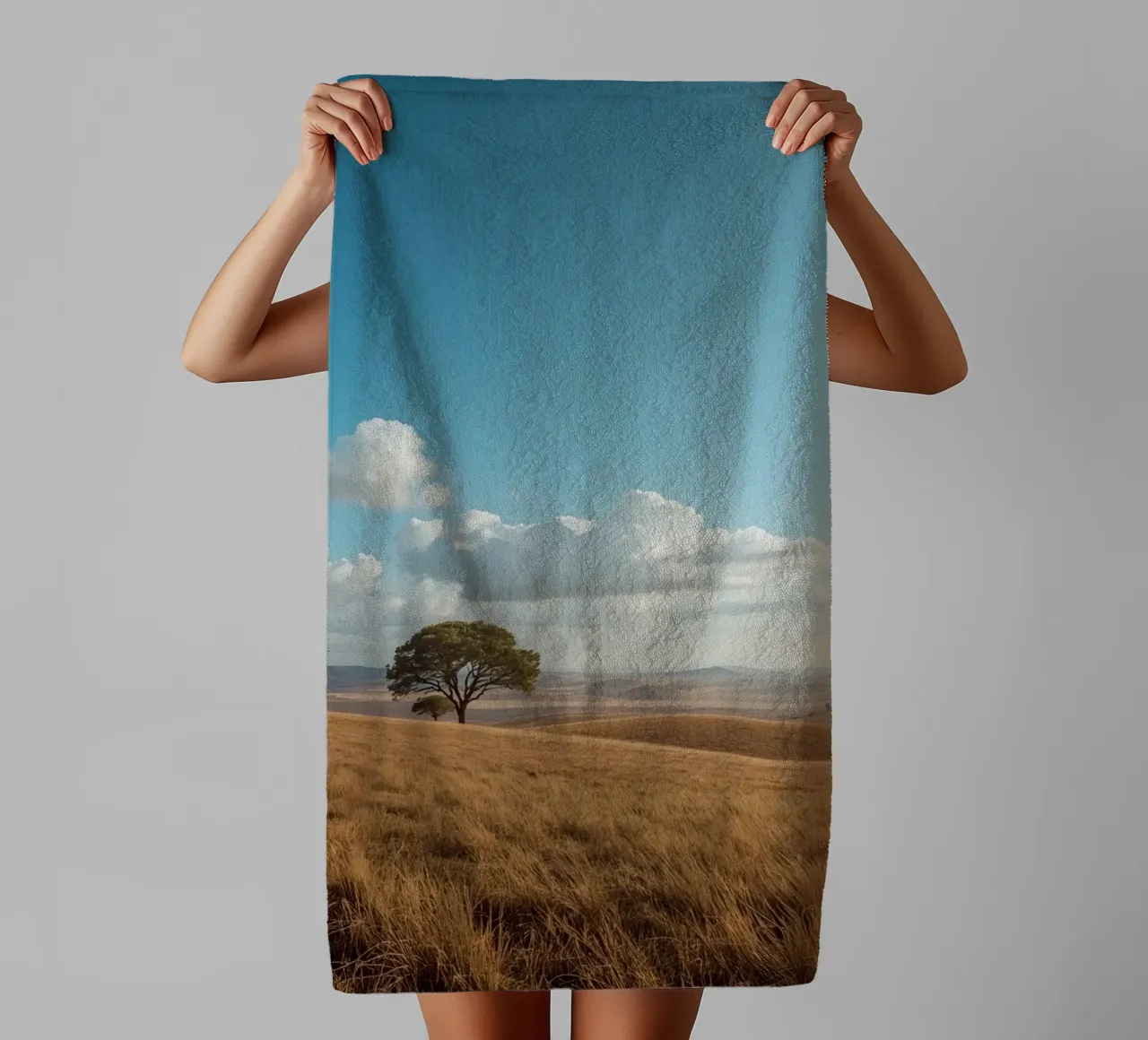 Grass Field with Tree under Cloudy Blue Sky towel by DesignDoodle