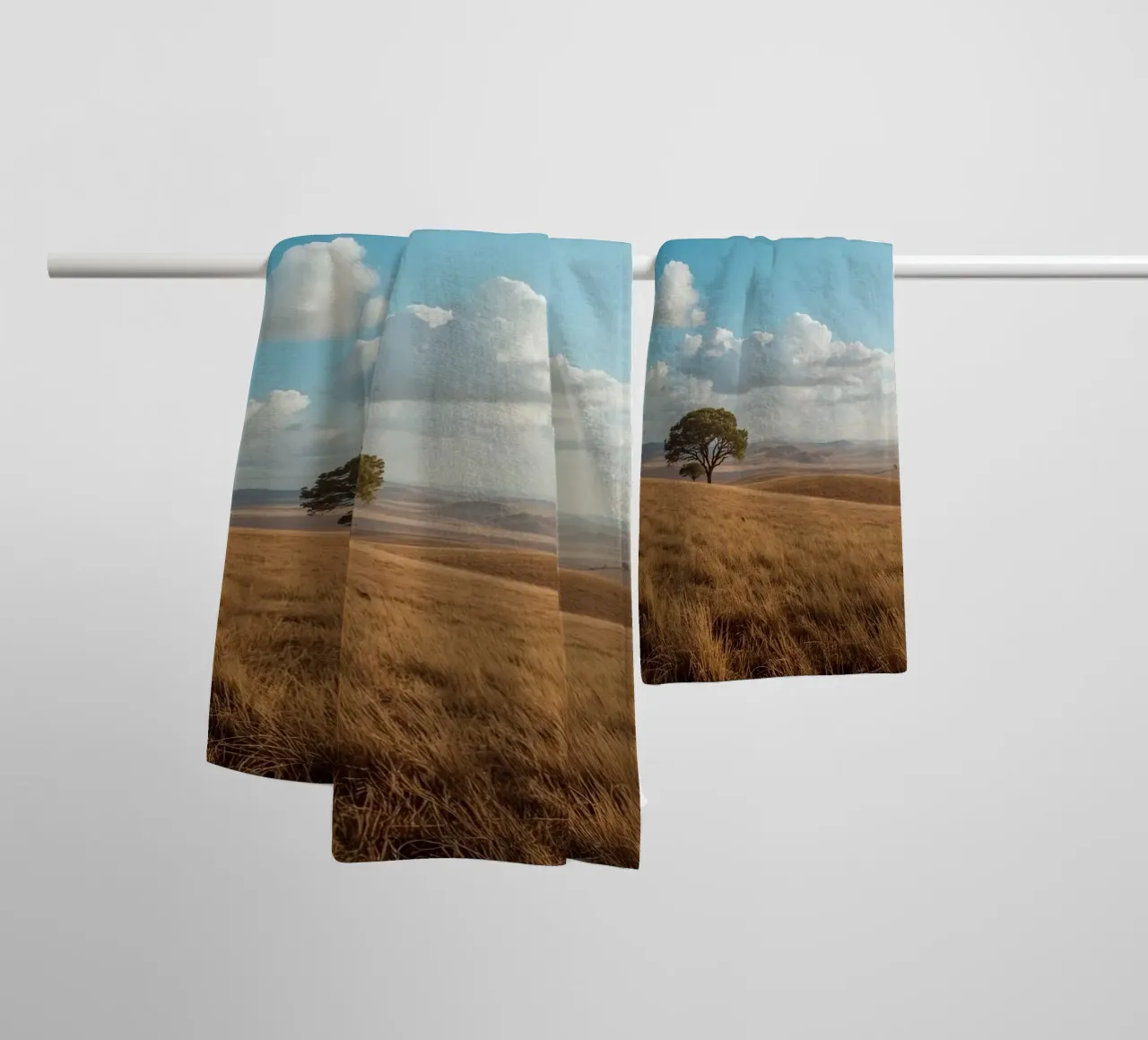 Grass Field with Tree under Cloudy Blue Sky towel by DesignDoodle