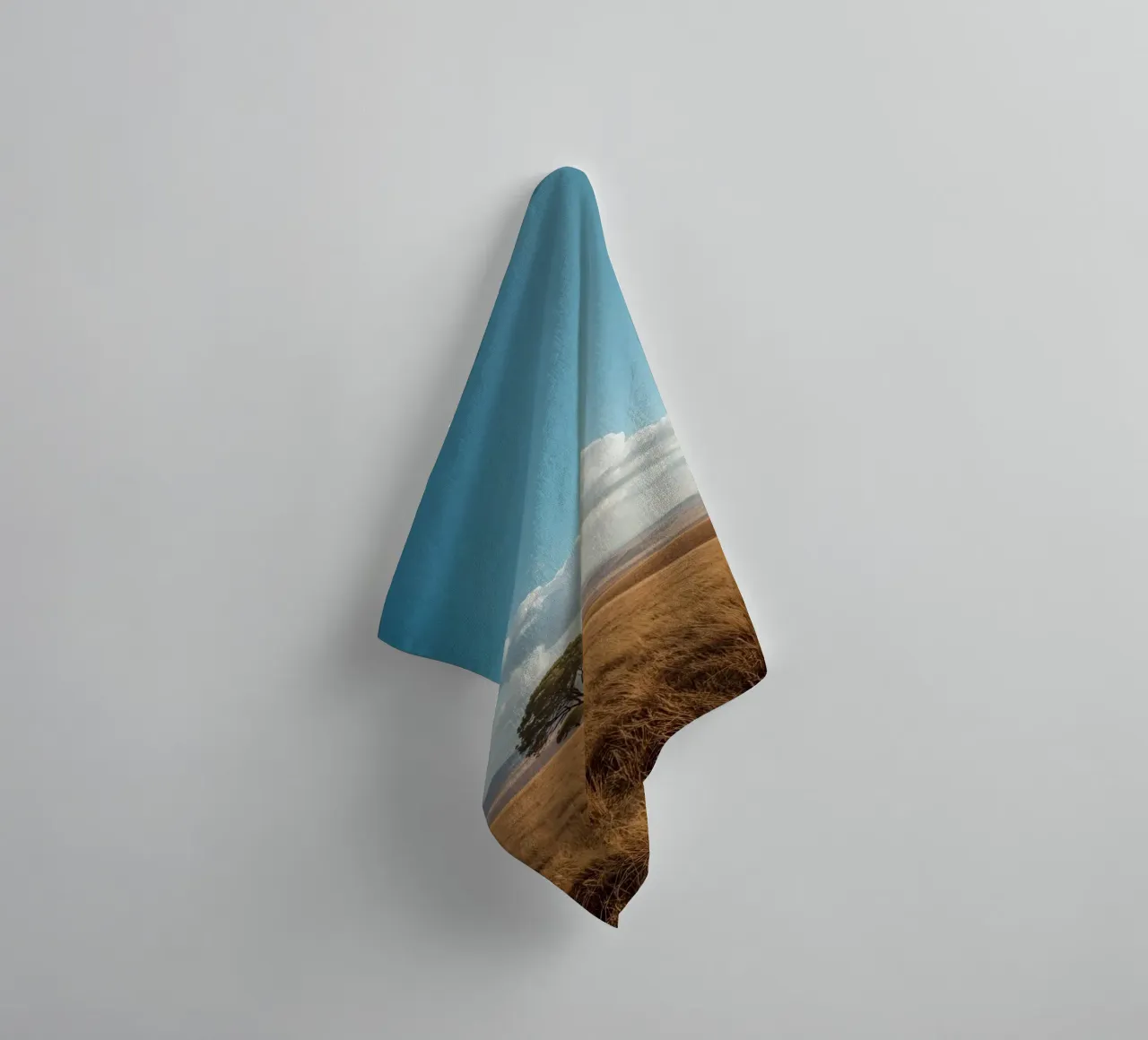 Grass Field with Tree under Cloudy Blue Sky towel by DesignDoodle