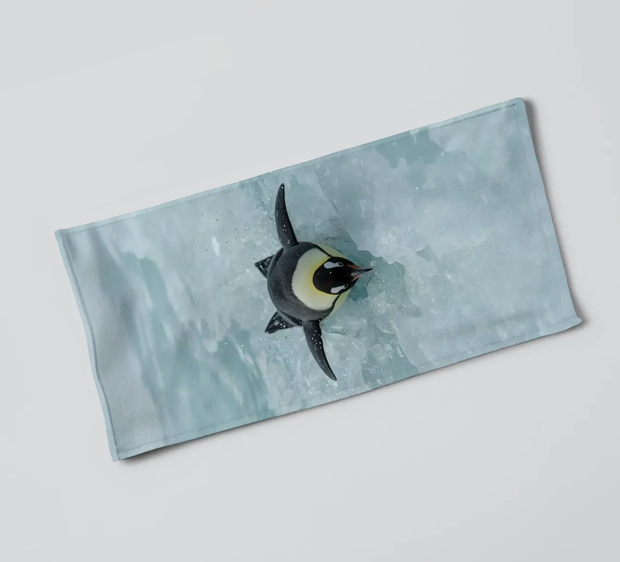 Emperor Penguin Skating in Ice Water towel by DesignDoodle