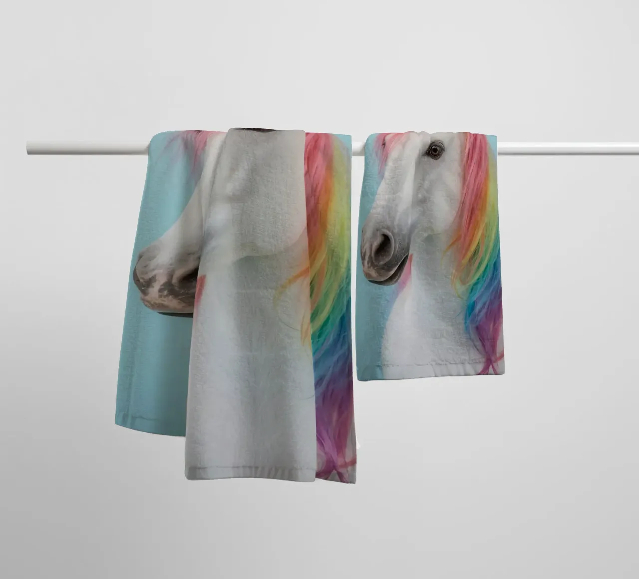 Unicorn with Rainbow Mane and Light Blue Background towel by DesignDoodle