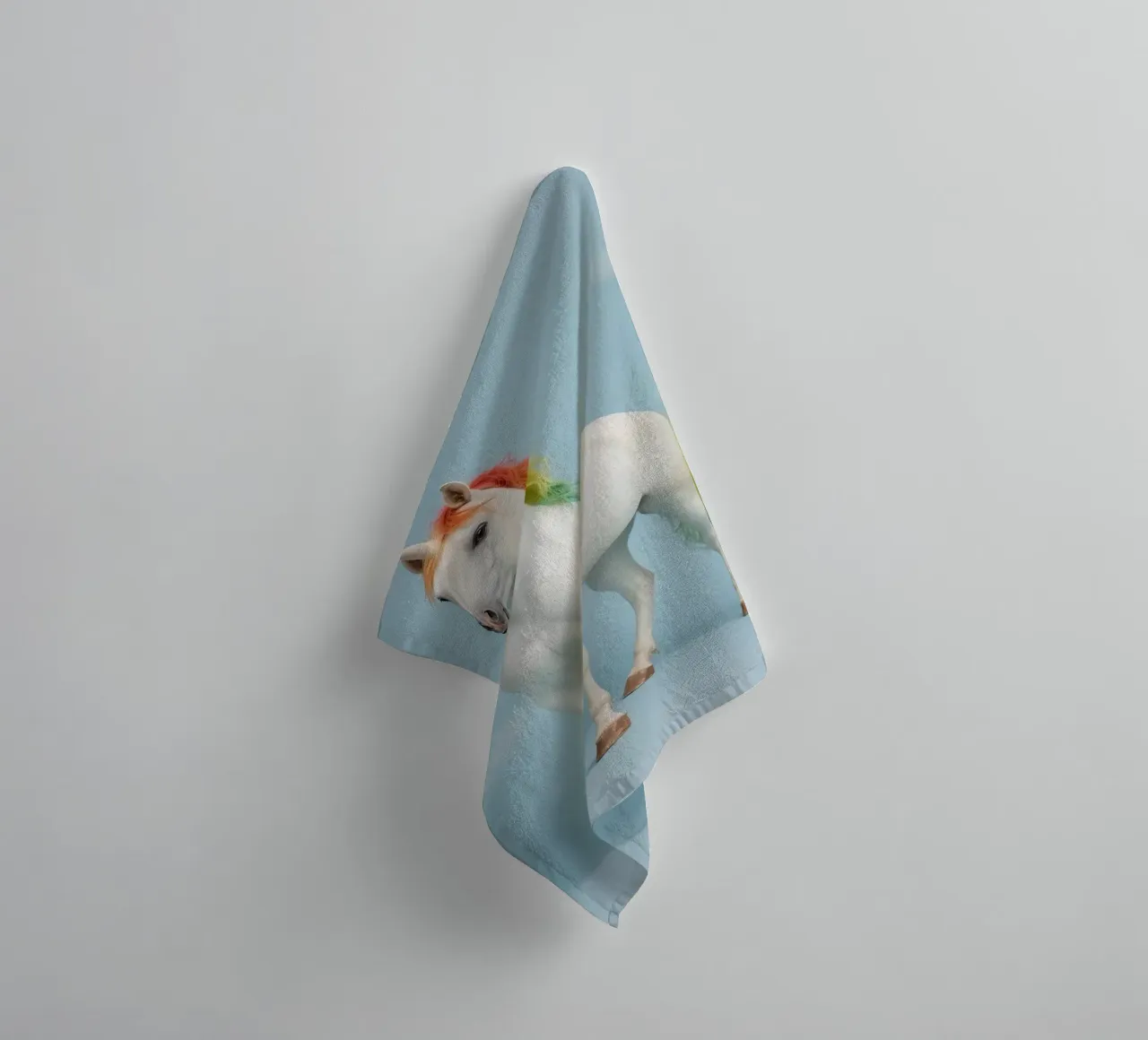 White Unicorn with Rainbow Mane and Tail on Blue Background towel by DesignDoodle